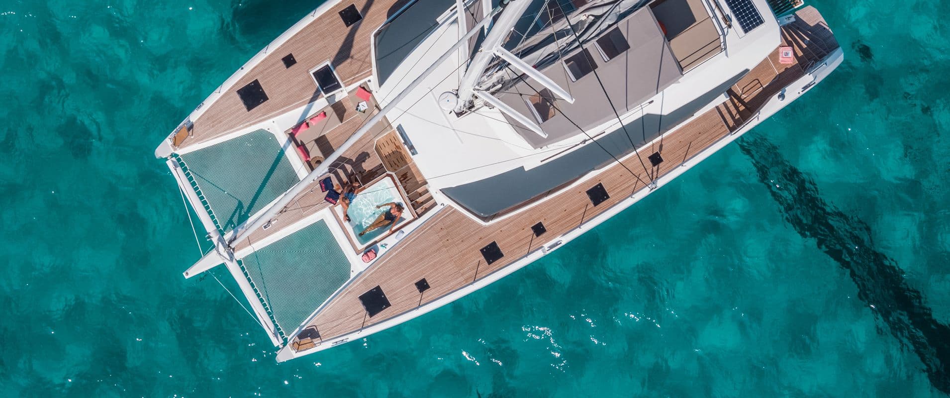 Aerial view of a luxury catamaran anchored in a turquoise Croatian bay