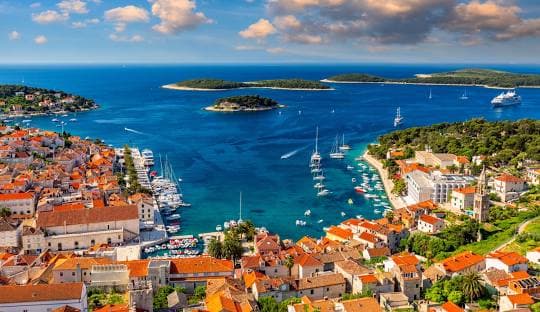 Hvar town and harbor with yachts anchored around the Pakleni Islands