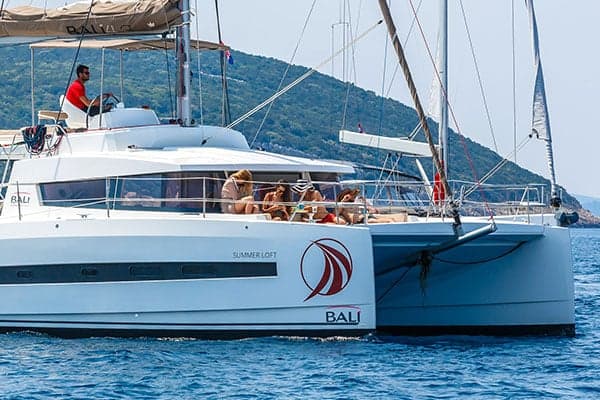 Skippered charter — professional skipper at the helm in Croatia